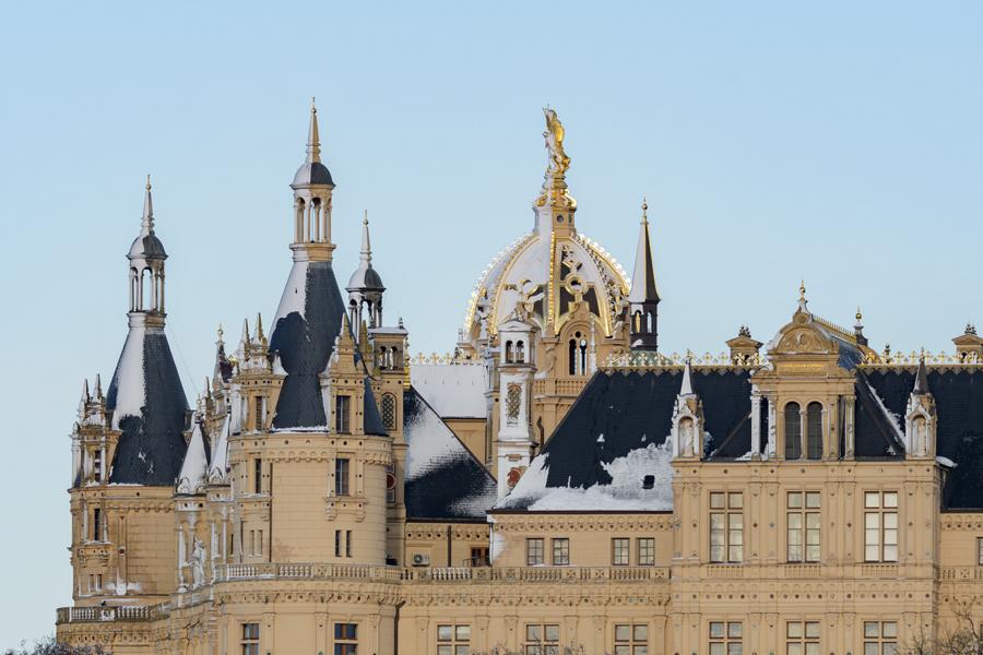 Schweriner Schlosskuppel mit schneebedeckten Türmen im Winter