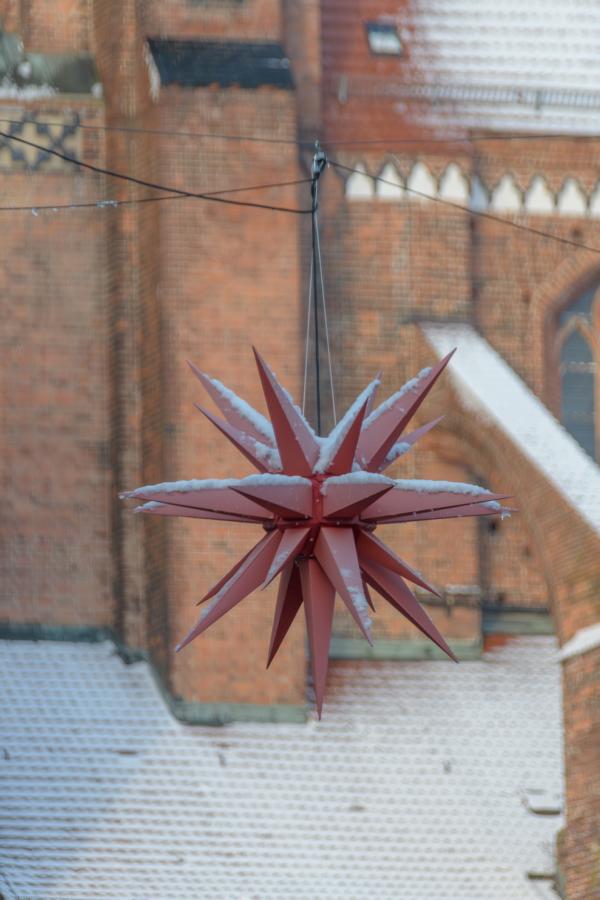 Roter Schneebedeckter Weihnachtsstern vor Schweriner Dom